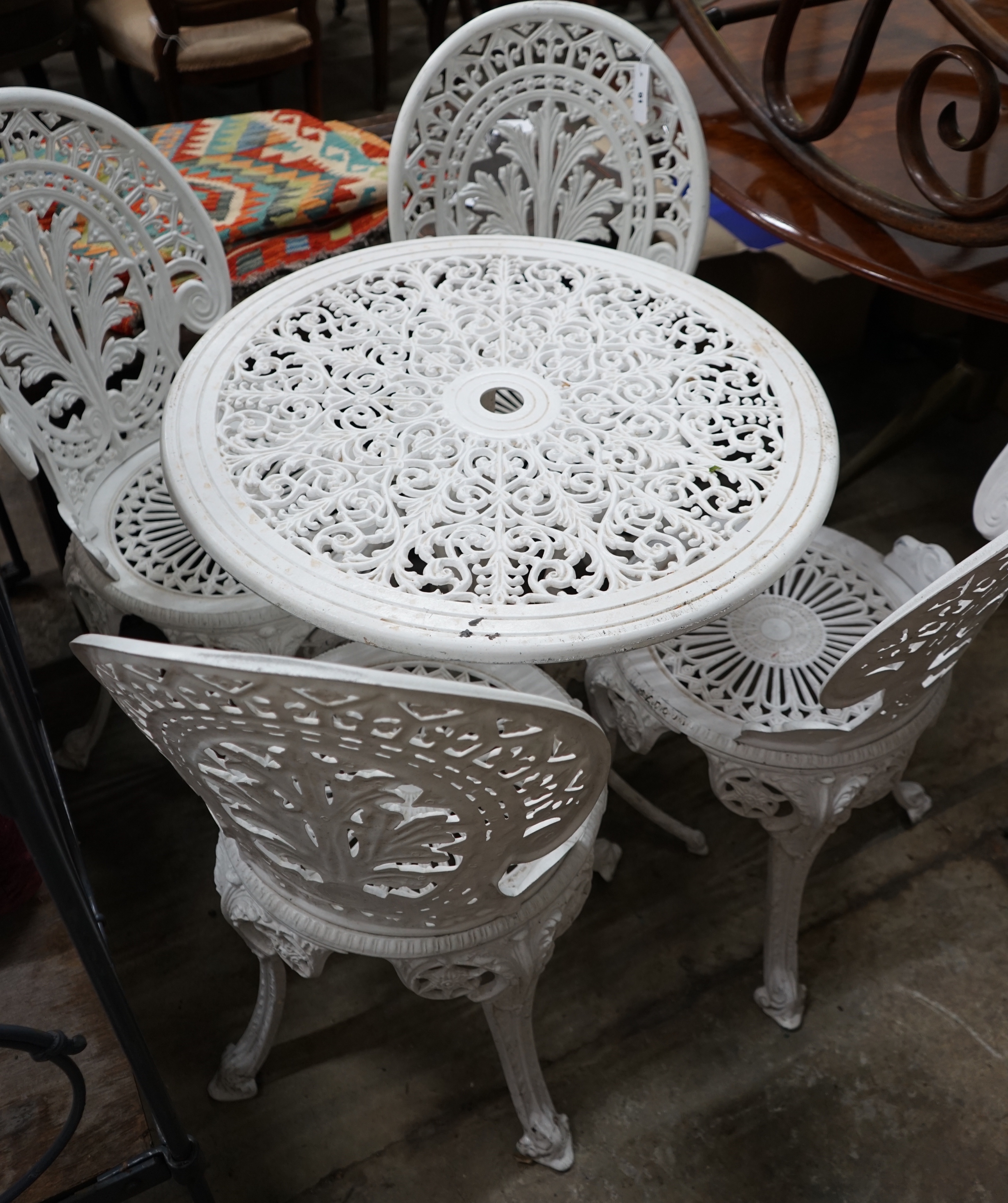 A Victorian style painted aluminium garden table and four chairs, table diameter 68cm height 65cm